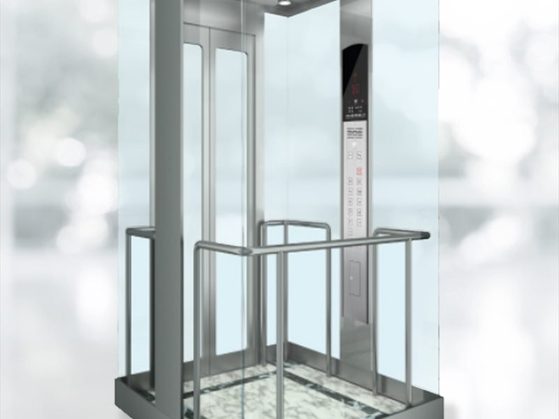 Glass elevator cabin interior looking out over a lobby